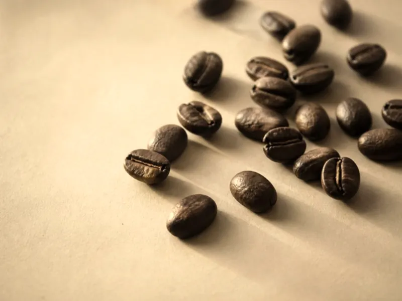 Roasted coffee beans, a few split open