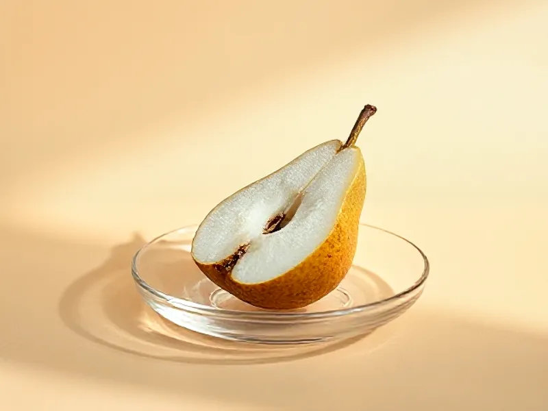 Frosted half pear on a glass dish