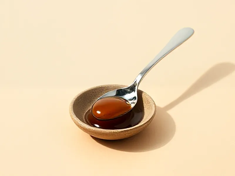 Dish of amber styrax balm with a spoon